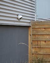 “The use of corrugated metal “was a very cost-effective cladding solution that pays homage to the metal-clad warehouse buildings in Lawrenceville,” Moss says, “but it does so in a manner that matches the scale of most of the lap-siding homes in the area.” The windows are mostly standard sizes from Pella.