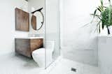 “What could I have that would feel luxurious, would make me feel really great?” muses one of the homeowners. “My husband and I travel a lot in Europe, and we always loved the marble showers. So we put a marble shower up against the window.” The sink and countertop are from Batimat, while the wall-hung vanity is another custom piece by Gepetto.