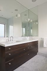 The clean symmetry of the master bathroom is enhanced by Ann Sacks ceramic Savoy tiles and Lefroy Brooks fixtures.