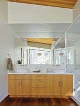 Talo Mini chrome sconces from Artemide installed atop the mirror in the master bathroom effectively disappear, becoming what Maca calls “subtle 3-D sculptures.” The Neo Blanco vanity, from Porcelanosa, is clad in the same Douglas fir as the ceiling. The IQ faucets are from Jado.