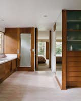 In the master bathroom and dressing room, pink-and-white floor tiles were found hidden under ’70s shag carpeting.