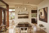 Removing a wall between the living and dining areas greatly improved the flow of the main level. The live-edge walnut dining table was made by Goby Walnut and the Wishbone chairs are by Hans Wegner.