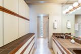 The master bath includes floor-to-ceiling cabinetry along one wall for ample storage.