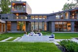 From the rear, the home’s layout as a two-story structure becomes clearer, as does its aggressive use of angular dimensions and expansive walls of glass.