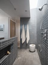 A view of the stylish master bathroom, which features a skylight above the shower.