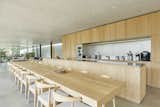 Leave it to Belgian architect Bruno Erpicum to create a sophisticated, minimalist dining area that seats 20 people. Designed for entertaining, this island home in Ibiza, Spain, incorporates a large dining table that is the same length as the kitchen and made in the same wood hue to present a clean and cohesive aesthetic.