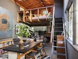Tucked away under the loft in this otherwise open space, the fireplace anchors a cozy nook.&nbsp;