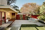 The living room flows onto a patio with an outdoor fireplace.