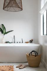 A1000xBetter took some square footage from an adjoining guest closet to create space for a freestanding tub. The hexagonal floor tile is by Arto.