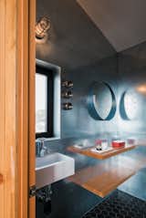 A powder room is tucked behind the kitchen’s pantry.
