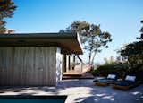 Concrete and travertine slabs were installed on the exterior, alongside an ipe deck with mahogany railings.