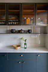 In the kitchen, custom cabinetry with transparent doors helps keep the space light and airy, as does a lower open shelf for tea, sugar and other everyday essentials.