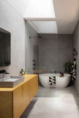 Here is the main bathroom located at the rear of the original dwelling's footprint. This area boasts an acrylic render finish to the walls, as well as a vaulted skylight that has been carved within the original roof.