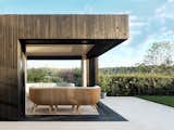 Two of the glass doors can be opened so that an entire corner of the structure practically disappears, and the residents have the feeling of being outdoors.