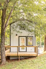 Black-painted window and door frames contrast with the white-painted steel siding and offer a crisp, clean aesthetic for the exterior of the cottage.