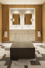 The master bathroom’s features a custom-made bench and marble mosaic flooring.