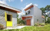 The listing includes a separate guest cottage with a bright yellow door.