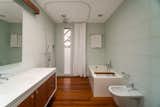 In the master bathroom, water from the shower drains straight through the wooden floor slats.