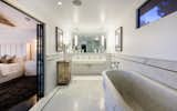 The master bath features marble throughout, including a deep marble soaking tub. 