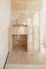 A sink located on lower level was installed as a place to wash off sand after returning from the beach—which is just a 10-minute walk away. The sink, wall, and flooring surrounding it are made of marés. Part of the flooring bears resembles to terrazzo; called "trespol," it's a mix of cement, marés powder, and small pebbles. Unlike terrazzo, the top surface of trespol is not polished. 