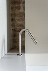 The bathroom sink is large, yet thin metal walls keep it unobtrusive.