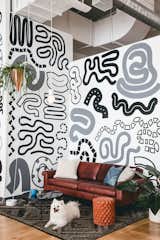 Organic painted patterns create a fun and inviting vibe in this open sitting space.