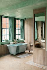 The bedroom connects with the bathroom, which has a large Water Monopoly bath in Avocado. 