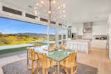 With a slightly outrageous form, this dining set is as eccentric as it is functional. Set in a sustainable luxury home designed by Stillwater Dwellings, the combination of the colorful rug, quirky chairs, and artsy chandelier is a setup meant for those who want to make an impression.