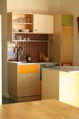 The new kitchen features an integrated steel sink, drawer dishwasher, and custom dish drying rack.