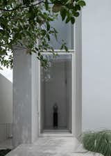 A sculpture from the owners' collection greets quests in the double-height entry foyer 