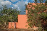 The geometric wall on one side acts as a screen to protect the structure from winds and noise. It also provides privacy for the living areas oriented towards the back of the house.