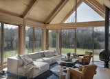 A Malm Firedrum 3 fireplace anchors the corner of the room opposite of the floor to ceiling windows.&nbsp;