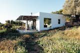 Campo Loft is surrounded by lush vegetation atop a mountainous hillside. 
