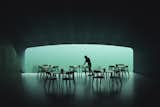 A 36-foot-wide and 11-foot-tall horizontal acrylic window—cut into the one-and-a-half-foot-thick concrete walls at the end of the tube-shaped restaurant—provides a panoramic portal to the wildlife outside. 