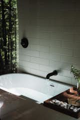 Master bath soaking tub view from glass wall partition.