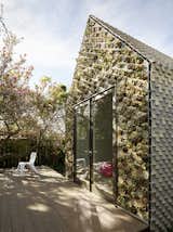 In response to the Bay Area’s housing crisis and a recent relaxation in ADU rules, Emerging Objects has crafted an experimental housing prototype: the Cabin of Curiosities. True to its name, the unusual structure is clad in over 4,500 3D-printed ceramic tiles and features a beautiful front facade full of succulents. The structure is envisioned as a livable or rentable ADU whose one-room gabled structure is weathertight, structurally sound, and designed for longevity.