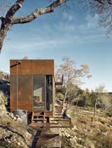 A low-impact design approach informed the compact, elevated footprint and grated metal walkways. Rainwater is channeled from the roof (covered in local stone) into a rain barrel.