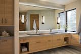 The lavish master bath features concrete counters with integrated sinks designed by the architect and design team. 