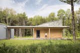 Completed in 10 months on a flat meadow atop a wooded bluff near the Cousins River estuary, the energy-efficient residence emphasizes indoor/outdoor living for a pair of nature lovers.