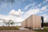 Untreated Lapacho timber planks—the same material used on the main house—clad the exterior of the two guest homes. In contrast to the horizontal cladding of the main house, the planks are vertically oriented here.