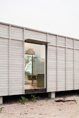 The home is elevated on pier foundations for reduced site impact.