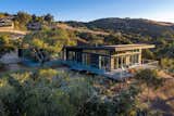Elevated on an oak-studded hillside lot, the three-bedroom, three-bath Waterfall Residence overlooks spectacular views in three directions.