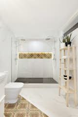 The floors of Avinyo Street Apartment were leveled by a topping slab of concrete, topped with large format ceramic tile.