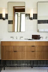Gleaming, warm baths feature products inspired by T.B. Rayl’s, one of the building’s previous occupants.
