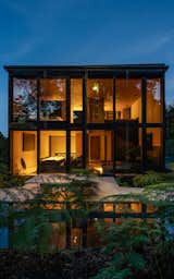 The main bedroom on the second floor takes advantage of the curtain wall's openness.