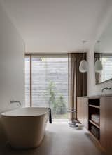 The master bathroom is located next to the bedroom and also opens up to the sunken courtyard.
