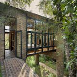 The aluminum windows are powder coated in a charcoal color, which is intended to match the shadows created by the forest and help the building further blend in.