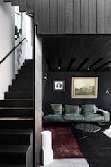 The couple often collect materials from warehouses and country yard sales. The exterior cladding is made from old Oregon timber beams from a warehouse in Sydney, while the joinery is crafted from cypress timber from wind-damaged trees that Chris purchased. "It’s about creating refined pieces from found materials," explains Chris.