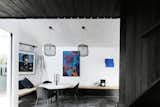 The couple kept the home’s color palette minimal to focus attention on their collection of artwork. There is, however, plenty of texture to lend visual interest. "Neither of us like plasterboard, and we wanted to play with handworked finishes and recycled materials," says Chris.&nbsp;