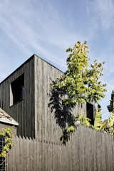 The couple initially intended for the dark cladding to be shou sugi ban. "It’s quite popular now, but back then you couldn’t get it," recalls Chris. "We tried charring the timber the traditional way by stuffing paper between the boards and lighting it, but we were putting fingerprints all over it. We then considered charing it while it was on the facade, but we thought we might burn our house down." Eventually, the couple decided to simply paint the timber, but they selected a finish that allowed the gnarly texture and knots to be show.&nbsp;